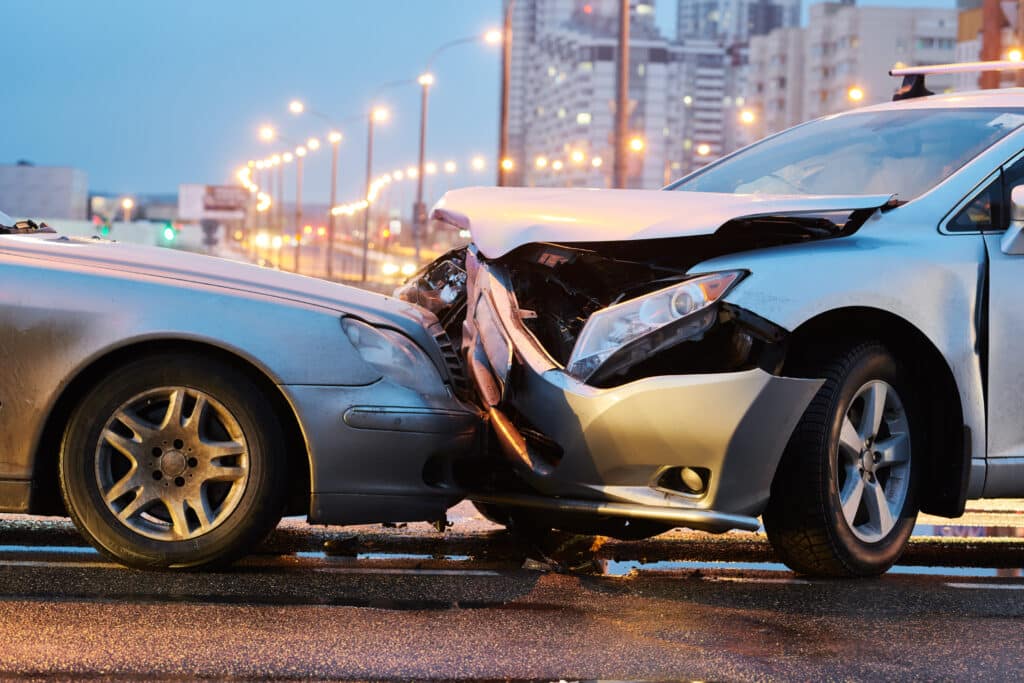 automobile crash accident. Car collision on city street. Two damaged vehicles